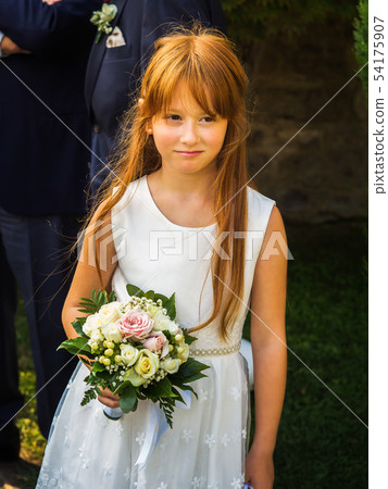 Flower girl in white dress with bouquet of roses Flower girl in white dress with bouquet of roses 54175907