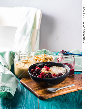 Healthy breakfast with berries and nut butter 54175935