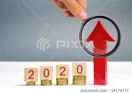 Wooden blocks 2020 and red arrow up. Wooden blocks 2020 and red arrow up. 54176751