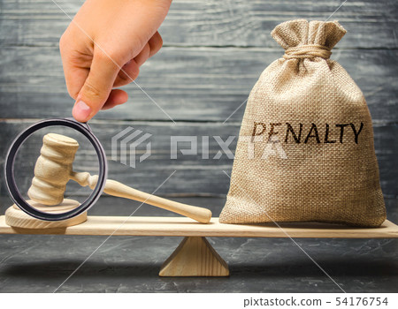 Bag with the word Penalty and gavel on the scales. Bag with the word Penalty and gavel on the scales. 54176754