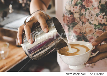 Close up of Barista making latte art. Close up of Barista making latte art. 54176984