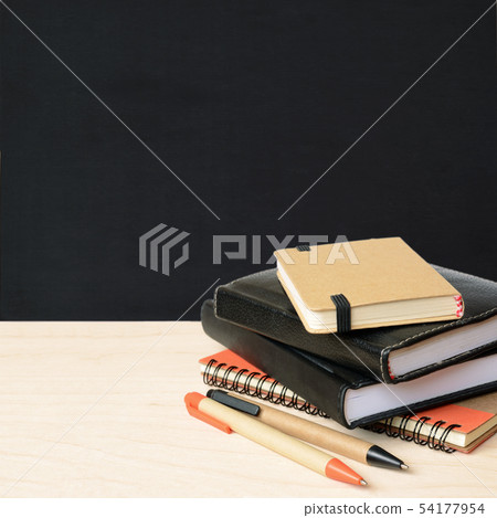 Notebooks and pens on wooden table with school 54177954