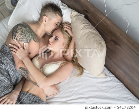 overhead view of couple sleeping in bed at home. Love and relationships concept overhead view of couple sleeping in bed at home. Love and relationships concept 54178204