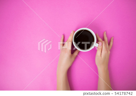 Flatlay with woman holding coffee mug with both hands. Flatlay with woman holding coffee mug with both hands. 54178742