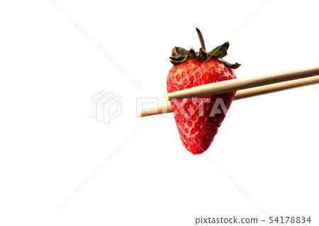 Chopsticks with ripe strawberry over white 54178834