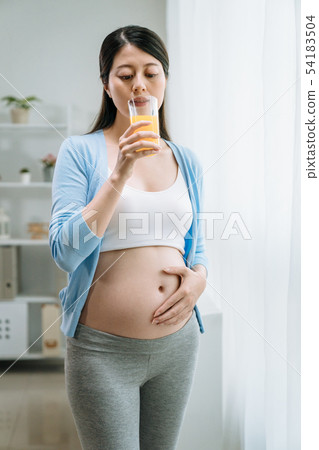 pregnant girl look fruit orange juice in hand pregnant girl look fruit orange juice in hand 54183504