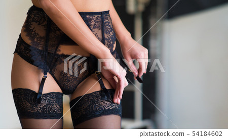 Closeup portrait of beautiful romantic young lady laying on white pillow and touching her face with 54184602