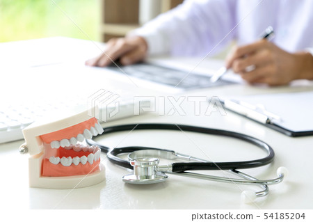 dentist work on the table with Denture and teeth dentist work on the table with Denture and teeth 54185204
