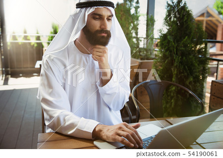 Arabian saudi businessman working outdoors 54190061