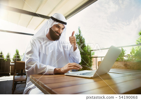 Arabian saudi businessman working outdoors 54190068
