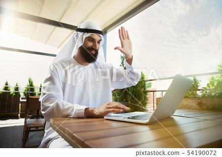 Arabian saudi businessman working outdoors 54190072