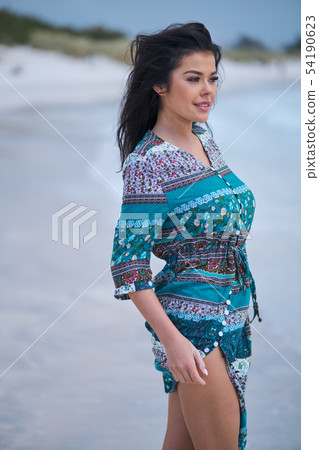 woman in the beautiful dress. walking on the beach 54190623