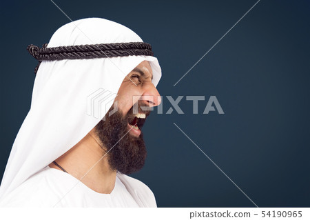 Arabian saudi businessman on dark blue studio background Arabian saudi businessman on dark blue studio background 54190965