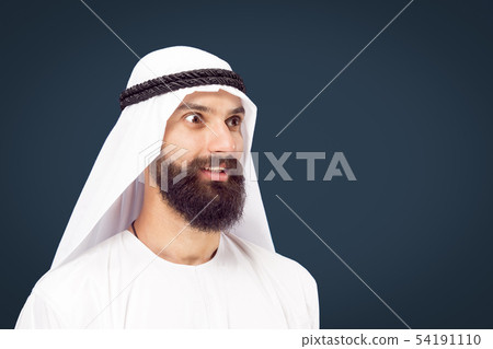 Arabian saudi businessman on dark blue studio background Arabian saudi businessman on dark blue studio background 54191110