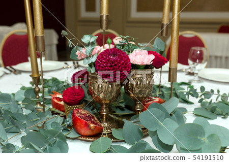 The wedding table setting is decorated with fresh 54191510