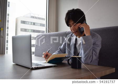 Youth taking notes while calling 54191737