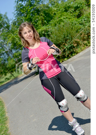 pretty young woman doing rollerskate on a track 54193009