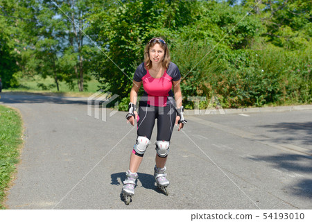 pretty young woman doing rollerskate on a track 54193010