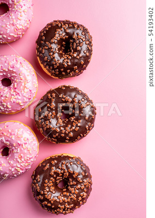 Colorful donuts on rose background Colorful donuts on rose background 54193402