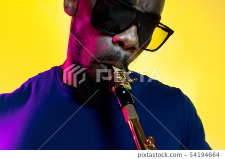 Young african-american jazz musician playing the saxophone 54194664