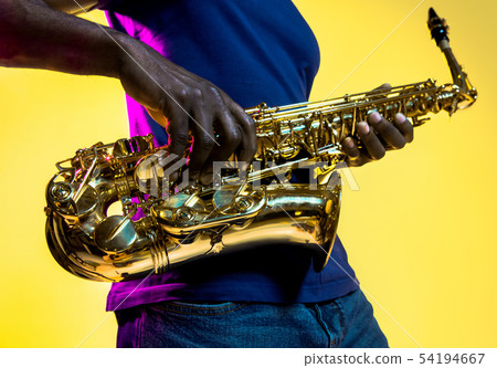 Young african-american jazz musician playing the saxophone Young african-american jazz musician playing the saxophone 54194667