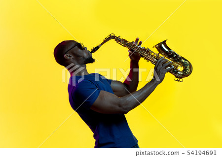 Young african-american jazz musician playing the saxophone 54194691