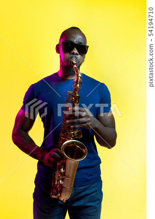 Young african-american jazz musician playing the saxophone 54194710
