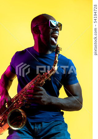 Young african-american jazz musician playing the saxophone Young african-american jazz musician playing the saxophone 54194728