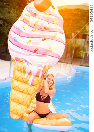 Beautiful young woman swims in the pool on Beautiful young woman swims in the pool on 54195455