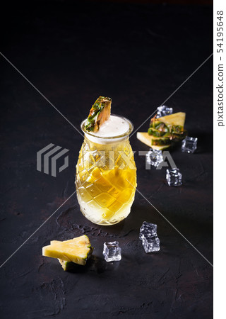 Pineapple cocktail with pulp in a glass on a Pineapple cocktail with pulp in a glass on a 54195648