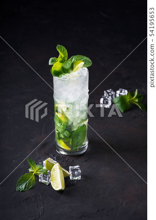 Mojito cocktail with lime, ice cubes and mint in Mojito cocktail with lime, ice cubes and mint in 54195653
