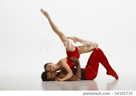 Young graceful couple of ballet dancers dancing on white studio background 54195735