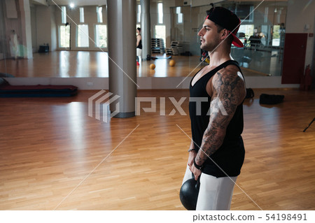 man in sportswear is training in the gym 54198491