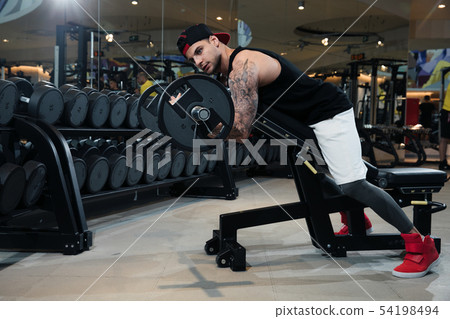 man in sportswear is training in the gym man in sportswear is training in the gym 54198494