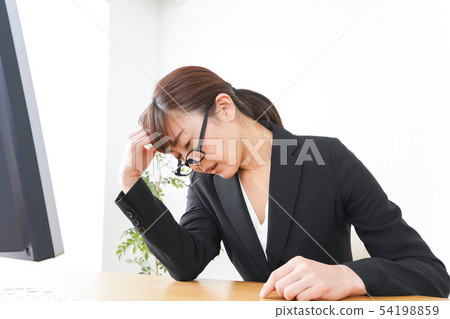 Business woman suffering from overwork, long working hours, overtime work 54198859