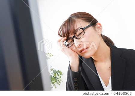 Business woman suffering from overwork, long working hours, overtime work Business woman suffering from overwork, long working hours, overtime work 54198865