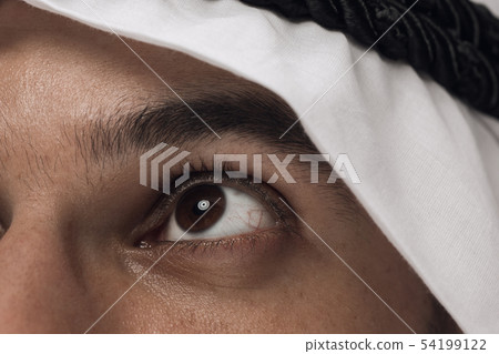 Arabian saudi man on dark blue studio background Arabian saudi man on dark blue studio background 54199122