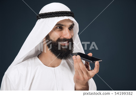Arabian saudi man on dark blue studio background 54199382