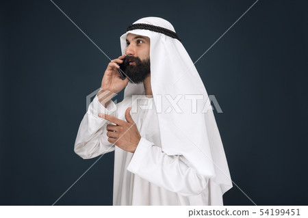Arabian saudi man on dark blue studio background 54199451