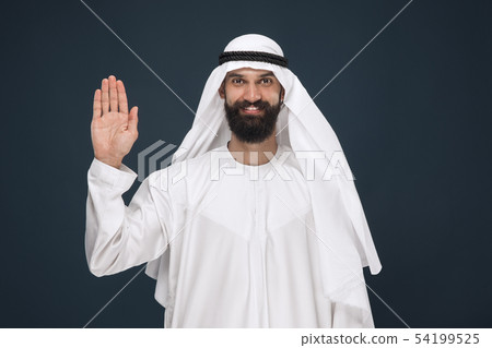 Arabian saudi businessman on dark blue studio background Arabian saudi businessman on dark blue studio background 54199525