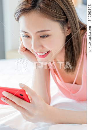 woman watch video by smartphone woman watch video by smartphone 54200308
