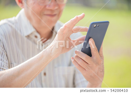 Older man use cellphone Older man use cellphone 54200410