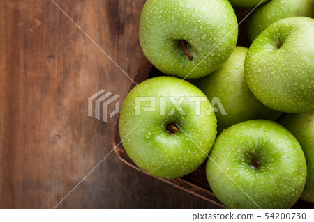 Ripe green apples in a wooden table. Ripe green apples in a wooden table. 54200730