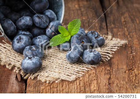 Blueberry on wooden table. Blueberry on wooden table. 54200731