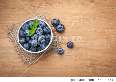 Blueberry on wooden table. Blueberry on wooden table. 54200734