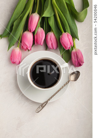 Black coffee in white Cup and tulips. Black coffee in white Cup and tulips. 54200846