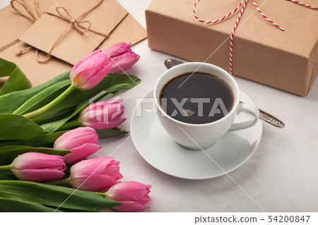 Black coffee in white Cup and tulips. Black coffee in white Cup and tulips. 54200847