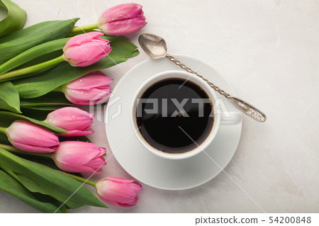 Black coffee in white Cup and tulips. 54200848