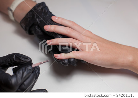 Manicurist doing a manicure at the beauty salon. Manicurist doing a manicure at the beauty salon. 54201113