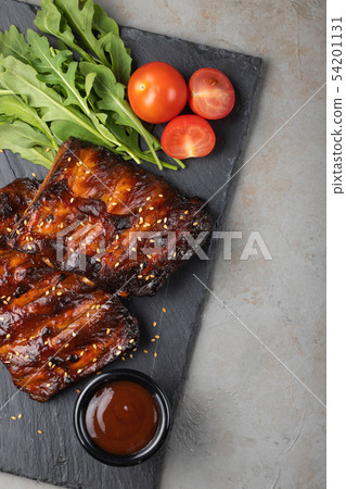 Closeup of pork ribs grilled with BBQ sauce. Closeup of pork ribs grilled with BBQ sauce. 54201131